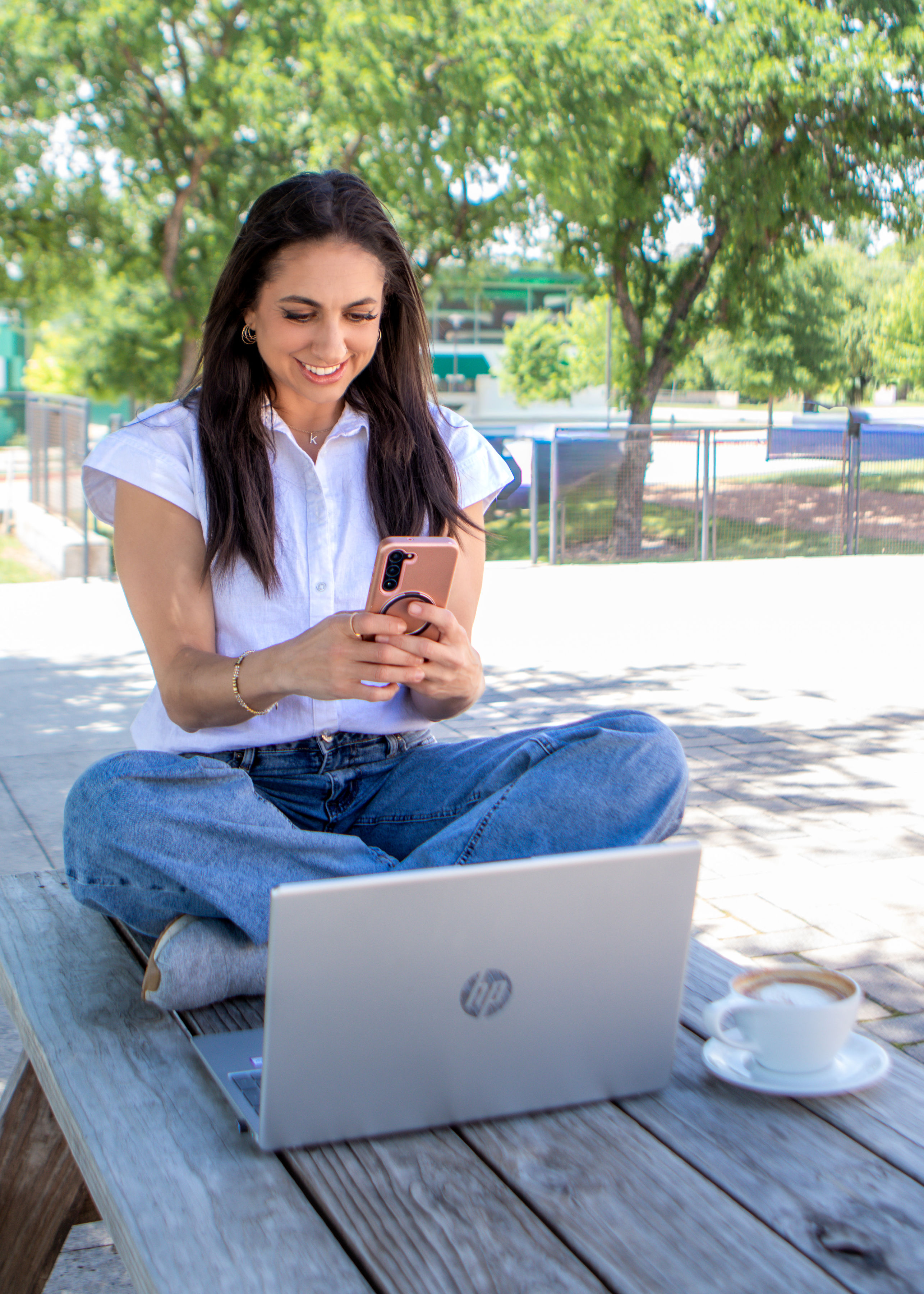 Karen Posner reviewing content on her phone